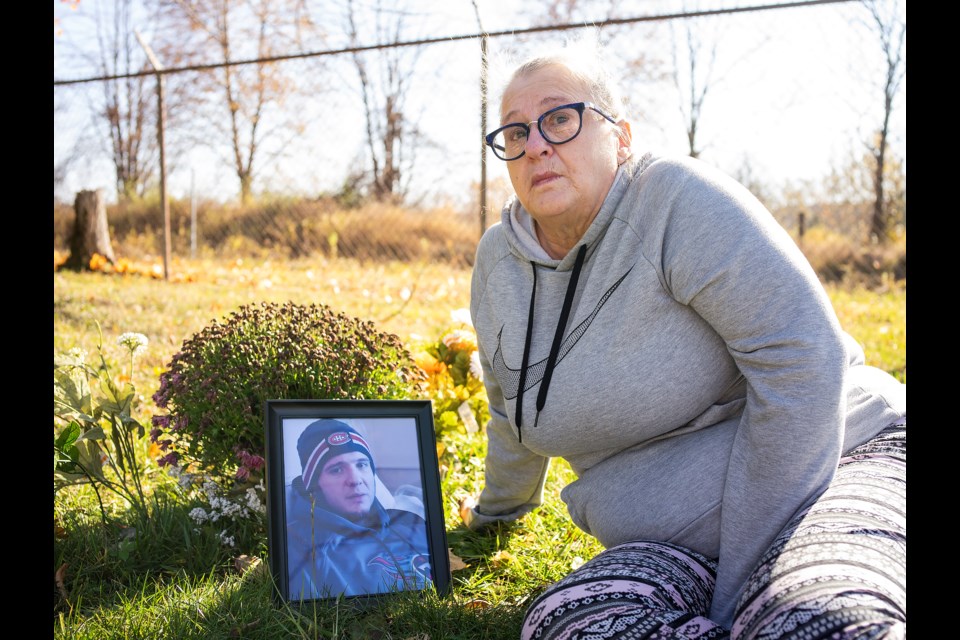 Heather Currie sits in Woodlawn Cemetery near the grave of her son, Justin Wright, who was severely injured in a single-vehicle collision after fleeing from police in November 2018. Wright died seven months later. Kenneth Armstrong/GuelphToday